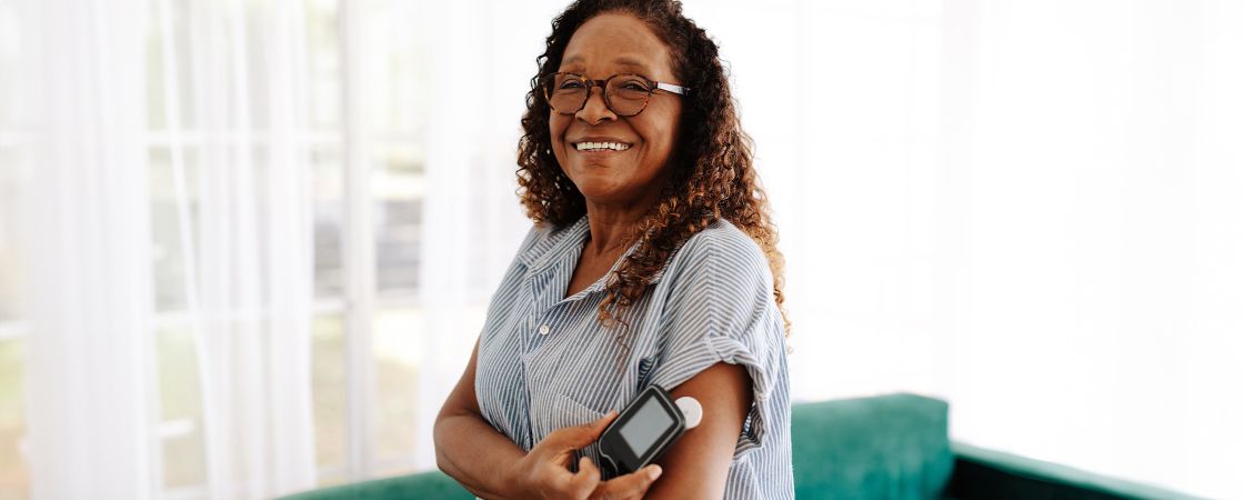 Women using diabetes arm monitor 