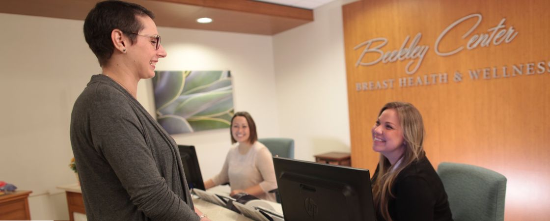 Patient speaking to front desk employees