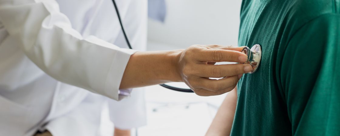 Doctor examining patient with stethoscope 