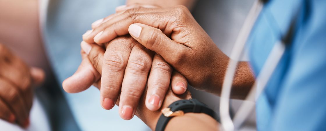 Nurse holding patients hand