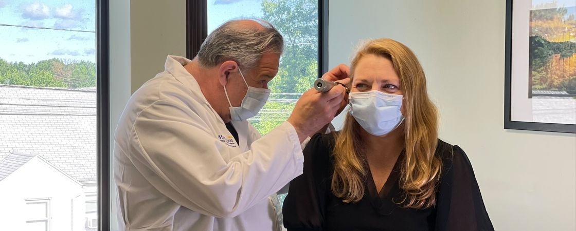 Doctor checking patient's ear