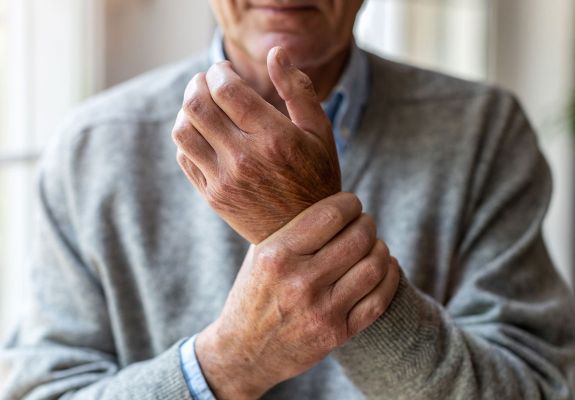 Man holding wrist in pain